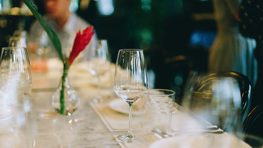 A glass of wine at a casual bar dining experience