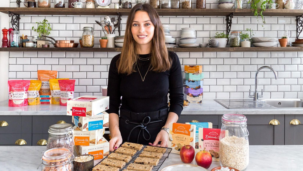 Woman in kitchen with vegan food products