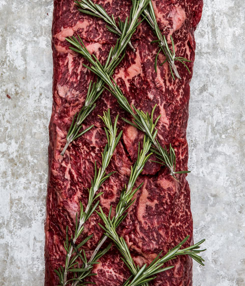 Side of beef with rosemary sprigs
