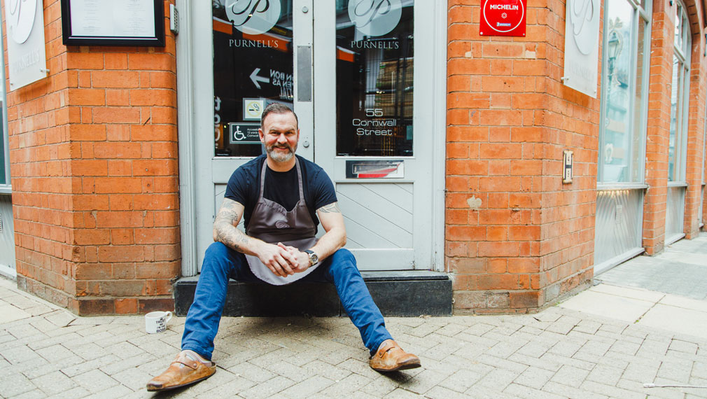 Glynn Purnell sitting on the doorstep of Purnell's