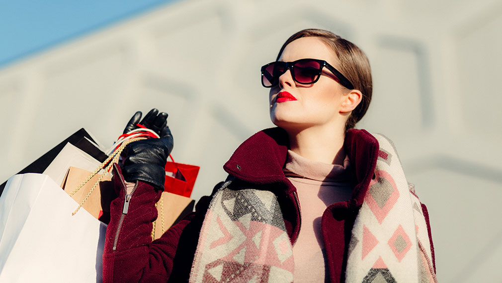 Fashionable woman shopping with sunglasses and bags