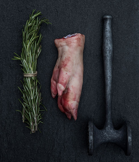 Still life photography of locally sourced and foraged rosemary and pigs trotters