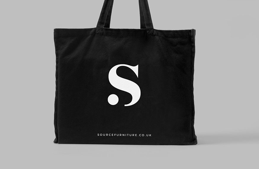 Minimal black tote bag design with branding for Source Furniture