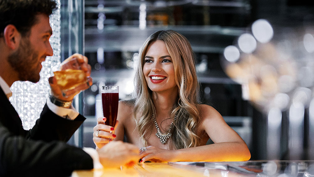 Lifestyle photography of couple enjoying drinks in the casino bar